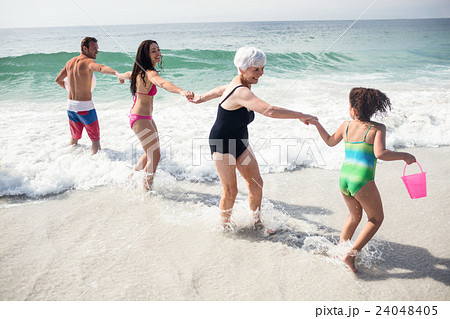 Happy family enjoying on beach Happy family enjoying on beach 24048405