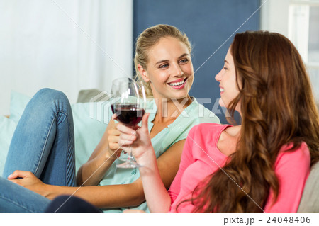 Happy female friends toasting wine 24048406