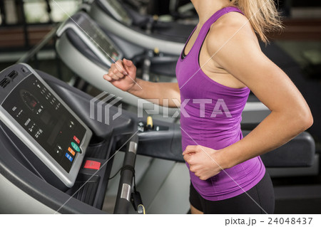 Woman walking on treadmill 24048437