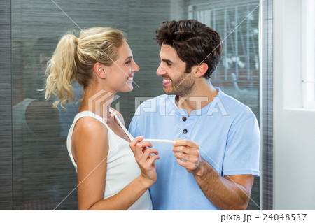 Happy couple checking pregnancy test Happy couple checking pregnancy test 24048537