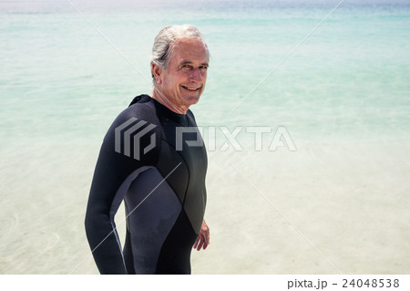 Portrait of happy senior man in wetsuit 24048538