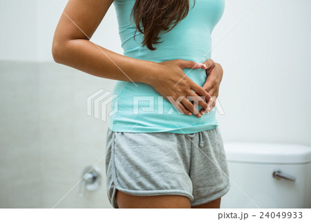 Woman touching her belly Woman touching her belly 24049933