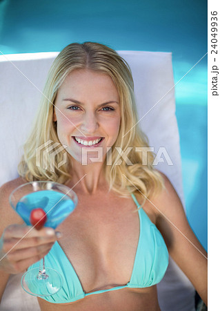 Beautiful woman in bikini relaxing on a sun lounger Beautiful woman in bikini relaxing on a sun lounger 24049936