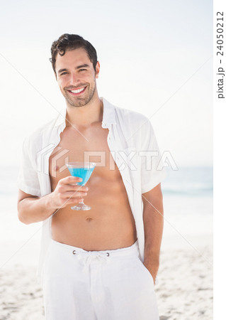Man posing and drinking cocktail 24050212
