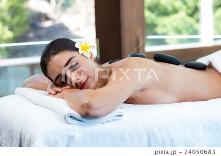 Beautiful woman receiving stone massage 24050683