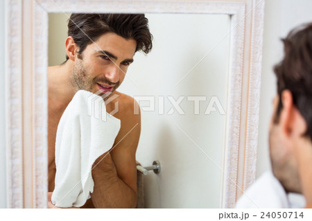 Man wiping his face with napkin Man wiping his face with napkin 24050714