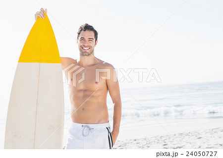 Man holding surfboard on the beach Man holding surfboard on the beach 24050727
