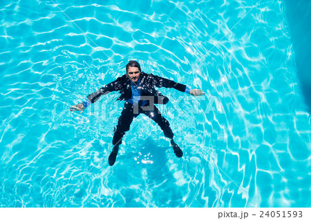 Dressed businessman in swimming pool Dressed businessman in swimming pool 24051593