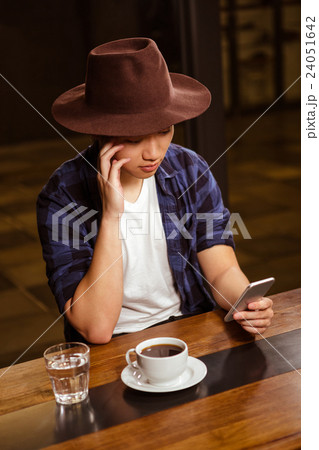 Man using his smartphone Man using his smartphone 24051642