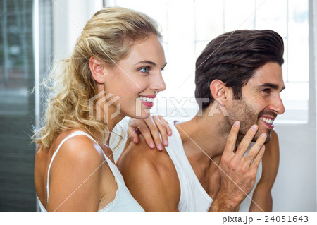 Man checking his stubble in bathroom Man checking his stubble in bathroom 24051643