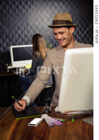 Creative businessman using computer and graphic tablet Creative businessman using computer and graphic tablet 24051645