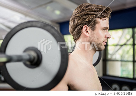 Man working out with barbell 24051988