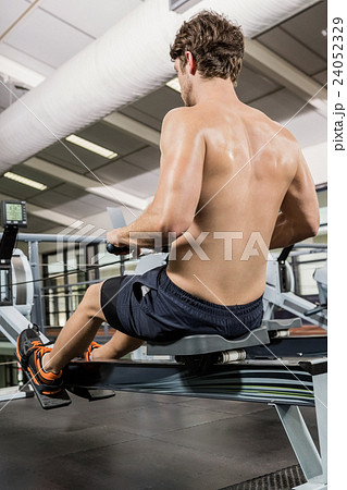 Man working out on rowing machine Man working out on rowing machine 24052329