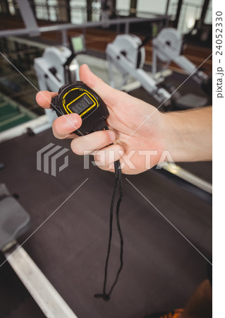 Hand of a trainer holding a stopwatch Hand of a trainer holding a stopwatch 24052330