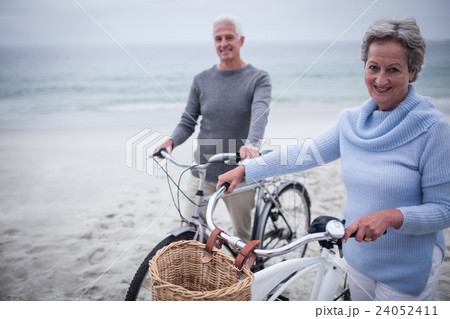 Happy senior couple with their bike 24052411