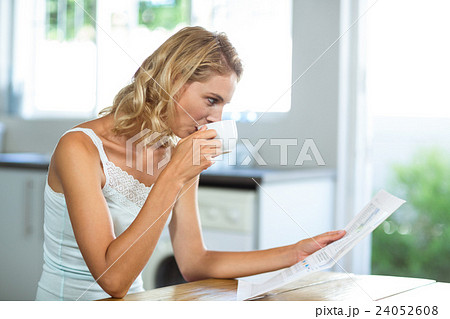 Beautiful woman reading newspaper 24052608
