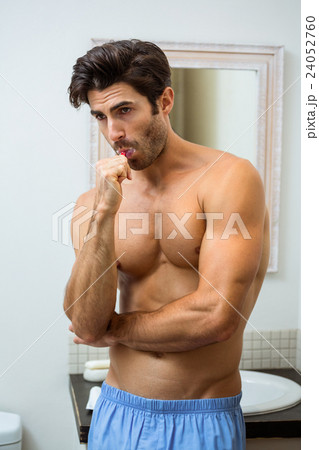 Young man brushing teeth Young man brushing teeth 24052760