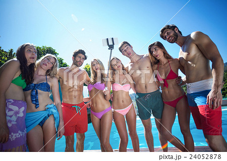 Happy friends in swimwear standing together Happy friends in swimwear standing together 24052878
