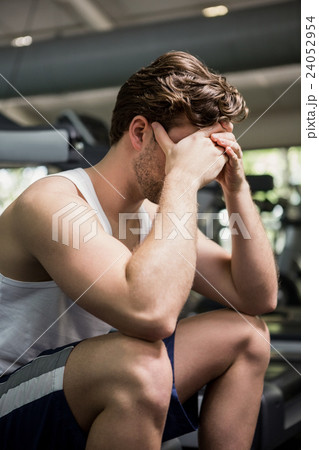 Tired man sitting on treadmill Tired man sitting on treadmill 24052954