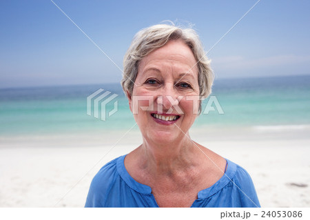 Portrait of happy senior woman on beach Portrait of happy senior woman on beach 24053086
