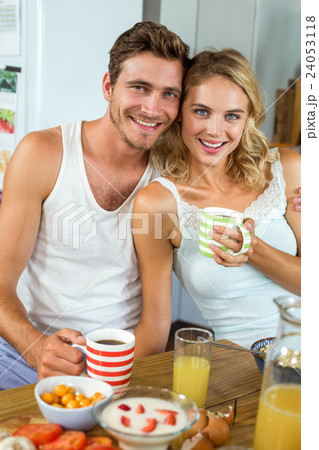 Loving couple having coffee at breakfast table in house Loving couple having coffee at breakfast table in house 24053118
