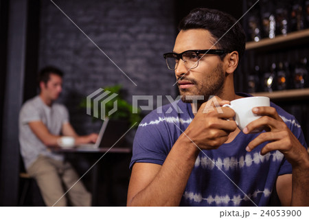 Man holding a cup of coffee Man holding a cup of coffee 24053900