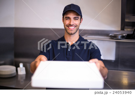 Pizza delivery man showing box Pizza delivery man showing box 24053940