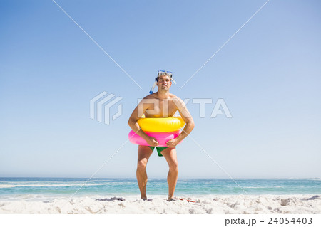 Smiling man posing with rubber ring Smiling man posing with rubber ring 24054403