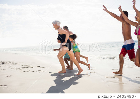 Happy family running on beach Happy family running on beach 24054907