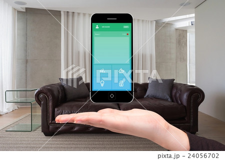 Hand showing home automation on phone Hand showing home automation on phone 24056702