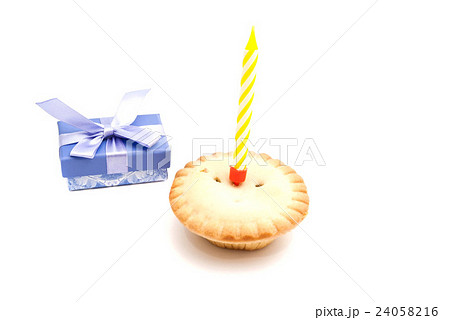 Cupcake with yellow birthday candle and gift Cupcake with yellow birthday candle and gift 24058216