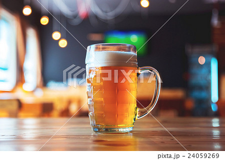 Glass of lager beer on a bar counter in pub  24059269