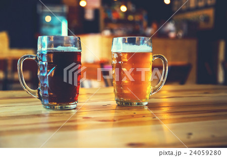 Goblets light and dark beer on a wooden table  24059280