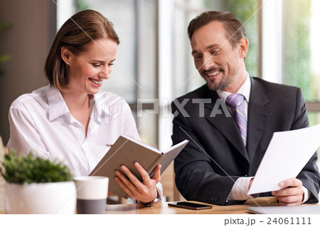 Cheerful colleagues sitting at the table 24061111