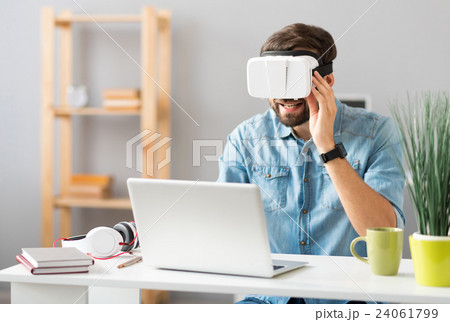 Cheerful man using virtual reality device 24061799