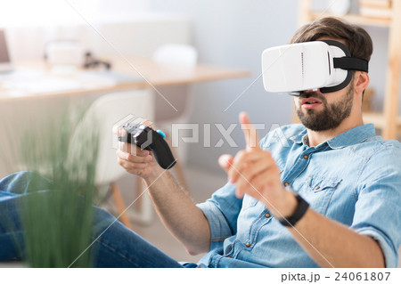 Pleasant concentrated man playing video games 24061807