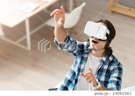Positive man using virtual reality device 24062062