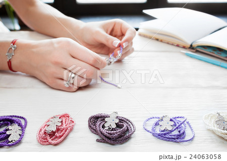 Woman making homemade bracelets Woman making homemade bracelets 24063058