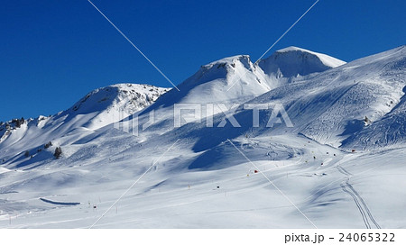 Snow covered mountains and ski slopes 24065322