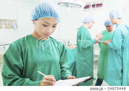 woman Surgeons writing medical record with teams 24073449