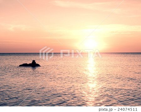 Romantic sea. Boulders stick out from smooth sea. 24074511