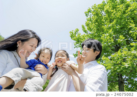 新緑の公園で遊ぶ4人家族 24075002