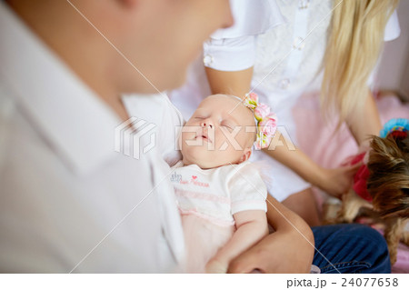 Babygirl sleeps on father's arms 24077658
