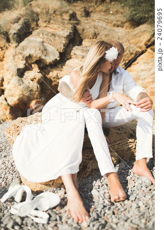 Young models couple posing on the beach with 24079695