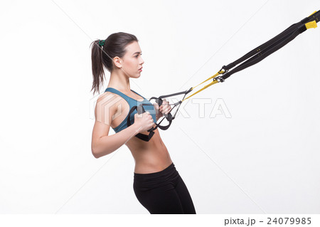 Woman training with suspension trainer sling 24079985