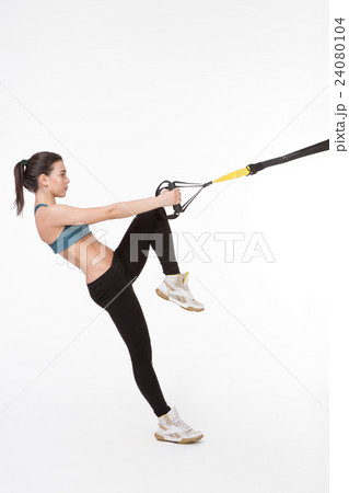 Woman training with suspension trainer sling 24080104