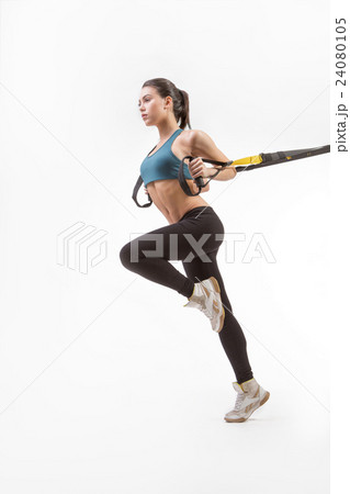Woman training with suspension trainer sling 24080105
