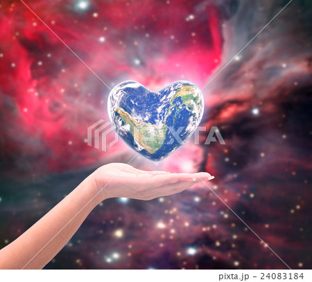 World in heart shape with over women human hands 24083184