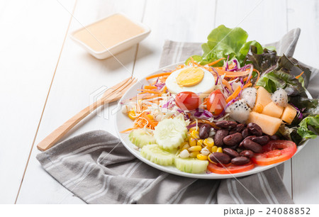 fresh mix salad on white wood background fresh mix salad on white wood background 24088852