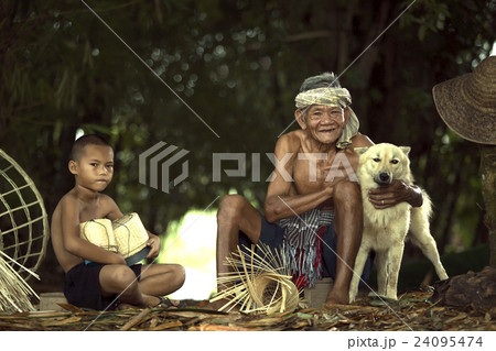 Senior fisherman with grandchild and dog Senior fisherman with grandchild and dog 24095474